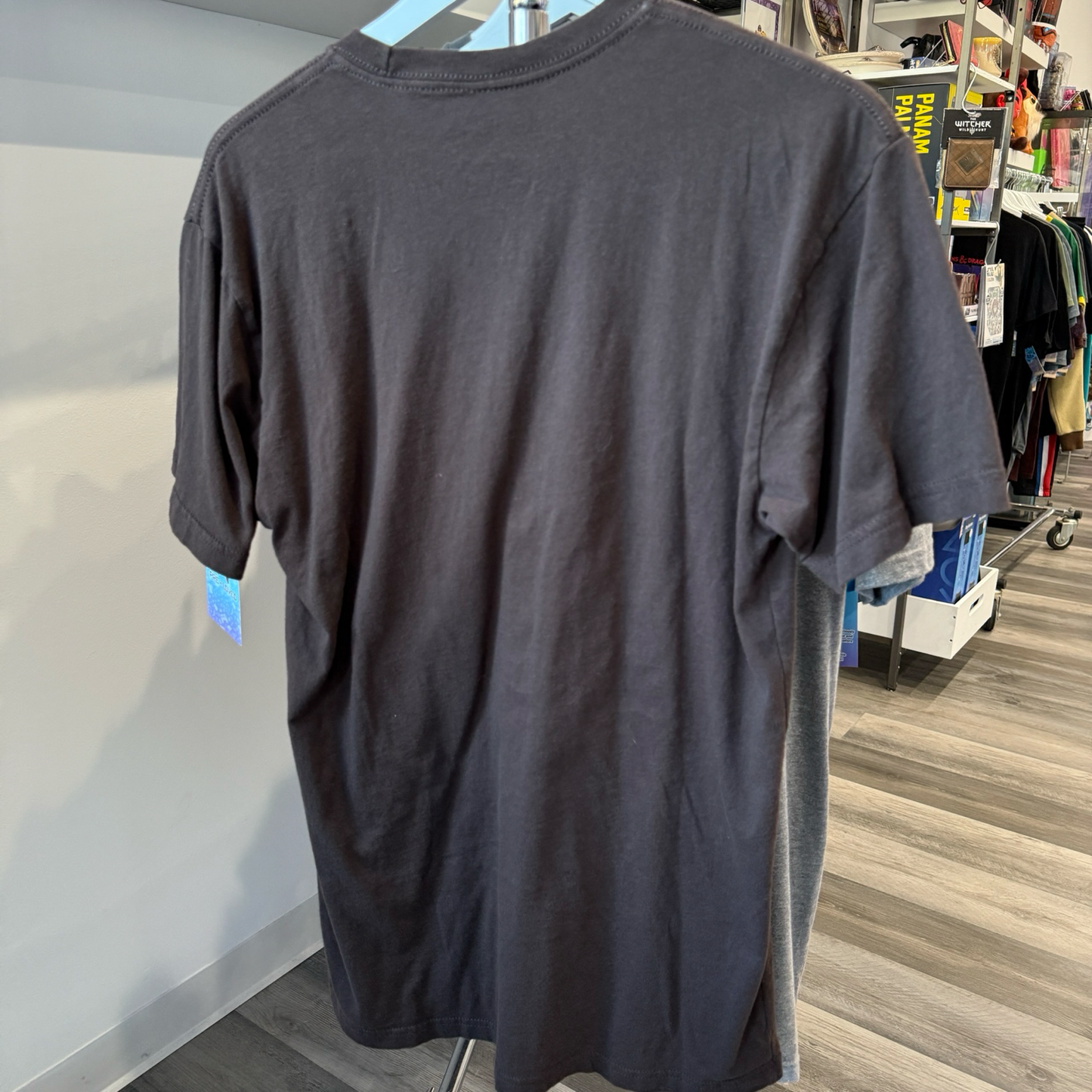 Back view of brown tshirt hanging on a rack