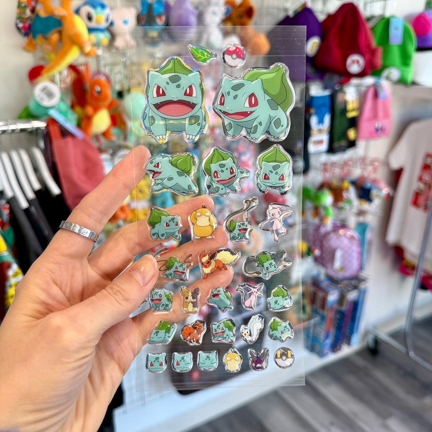 Clear sticker sheet featuring Pokemon Bulbasaur with a store in the background