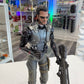 Action figure in a store setting with shelves in the background