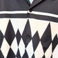 Close-up of a shirt with black and white geometric pattern