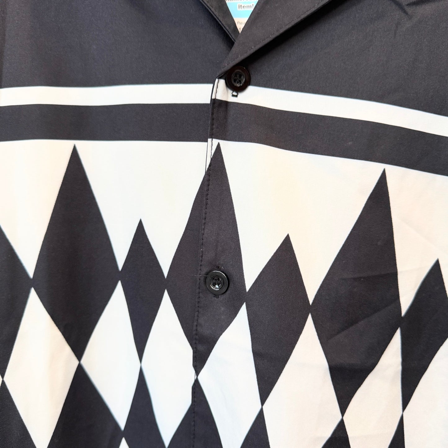 Close-up of a shirt with black and white geometric pattern