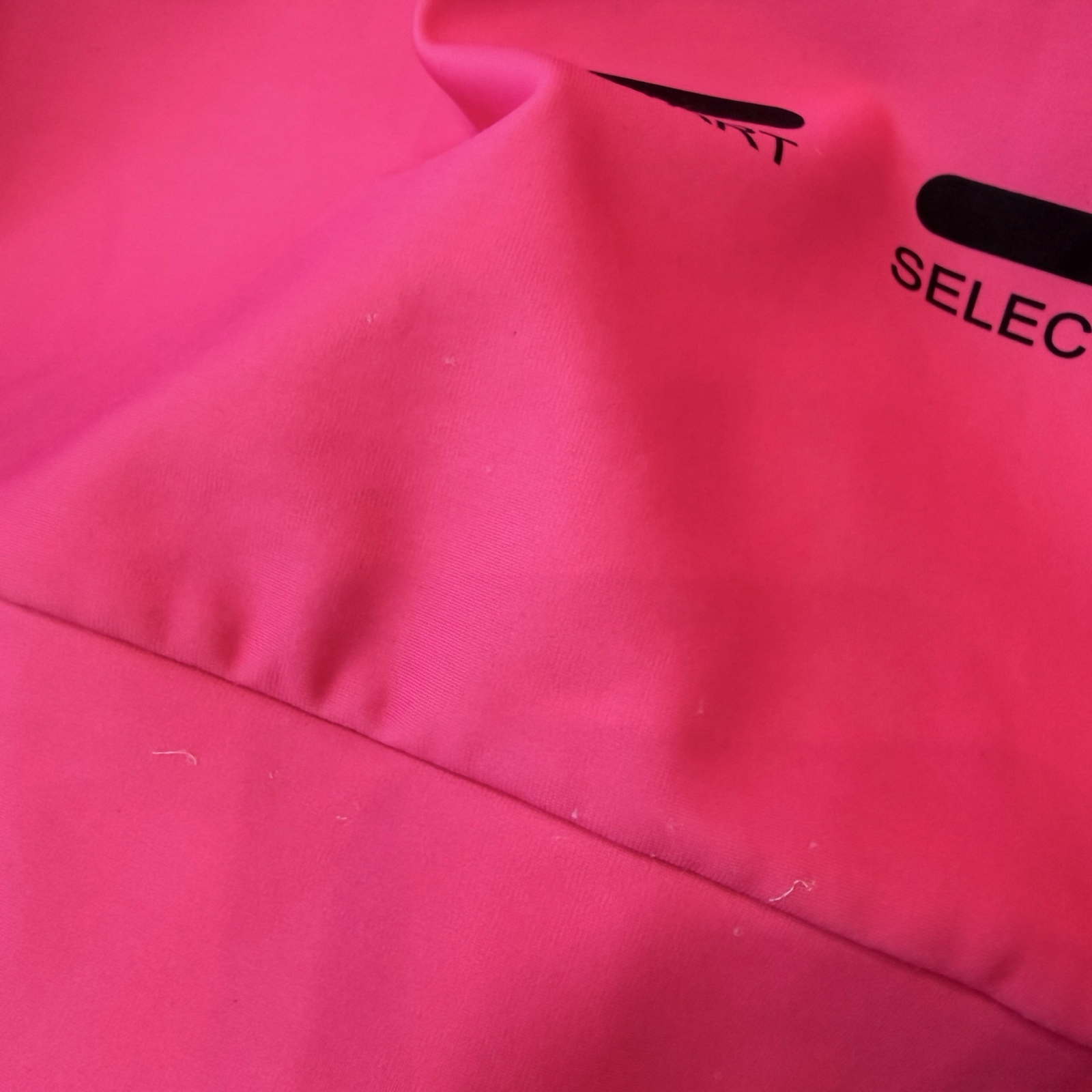 Hot pink fabric showing some snags and pulls in fabric. 