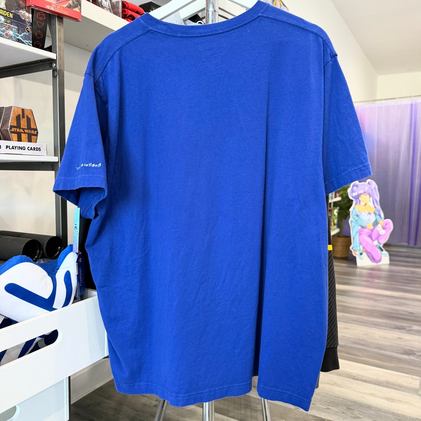 Back of blue tshirt inside a store