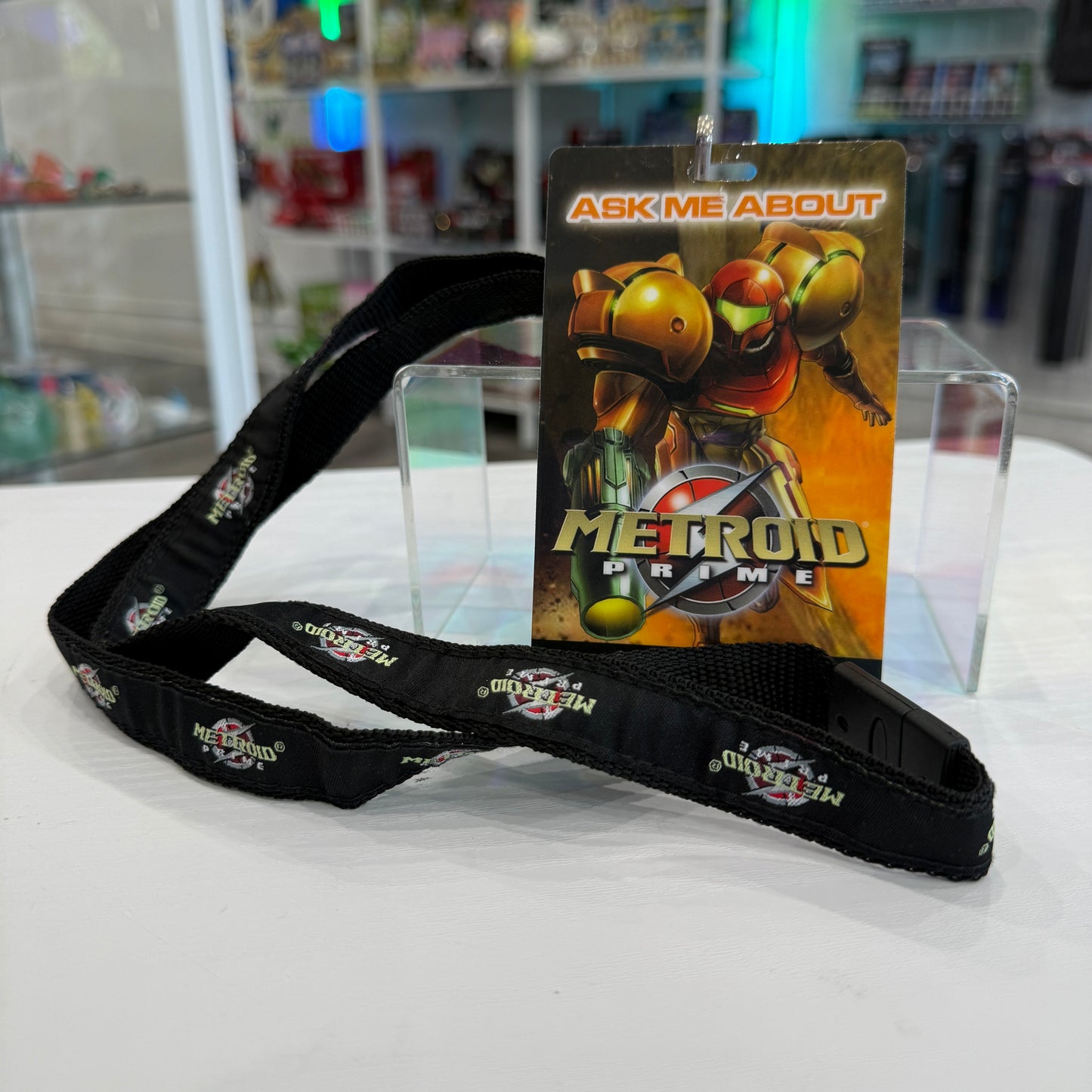 Lanyard with 'Metroid Prime' card on a white surface
