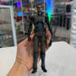Action figure held in a hand with a store shelf in the background