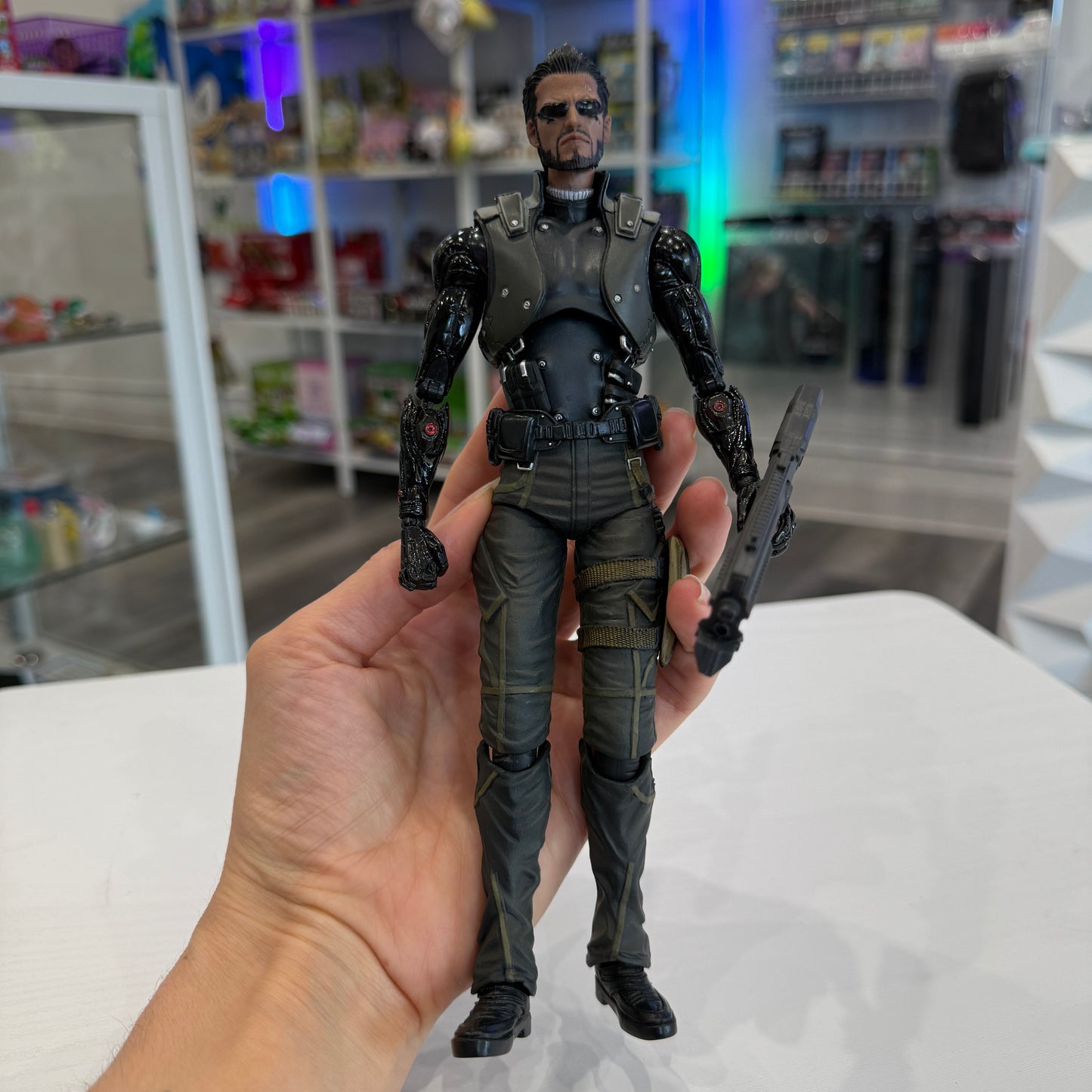 Action figure held in a hand with a store shelf in the background
