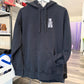 Black hoodie with 'The Last of Us' logo on a rack in a store.