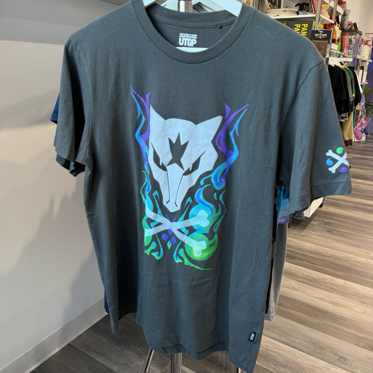 Grey tshirt with Pokémon Alolan Marowak graphic in purple, blue, and green
