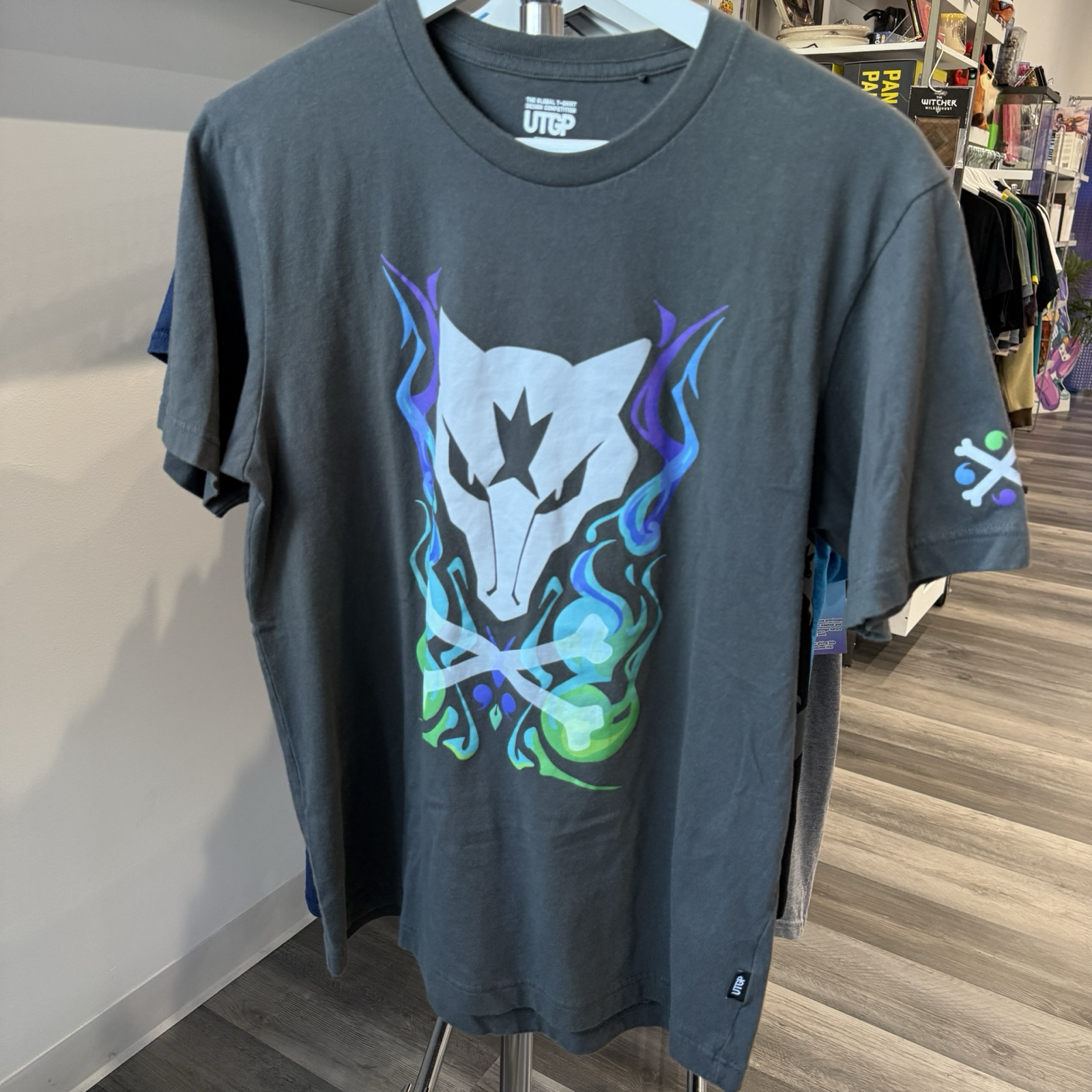 Grey tshirt with Pokémon Alolan Marowak graphic in purple, blue, and green