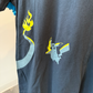 Upclose view of Pikachu and Charizard's tail graphic on black tshirt 