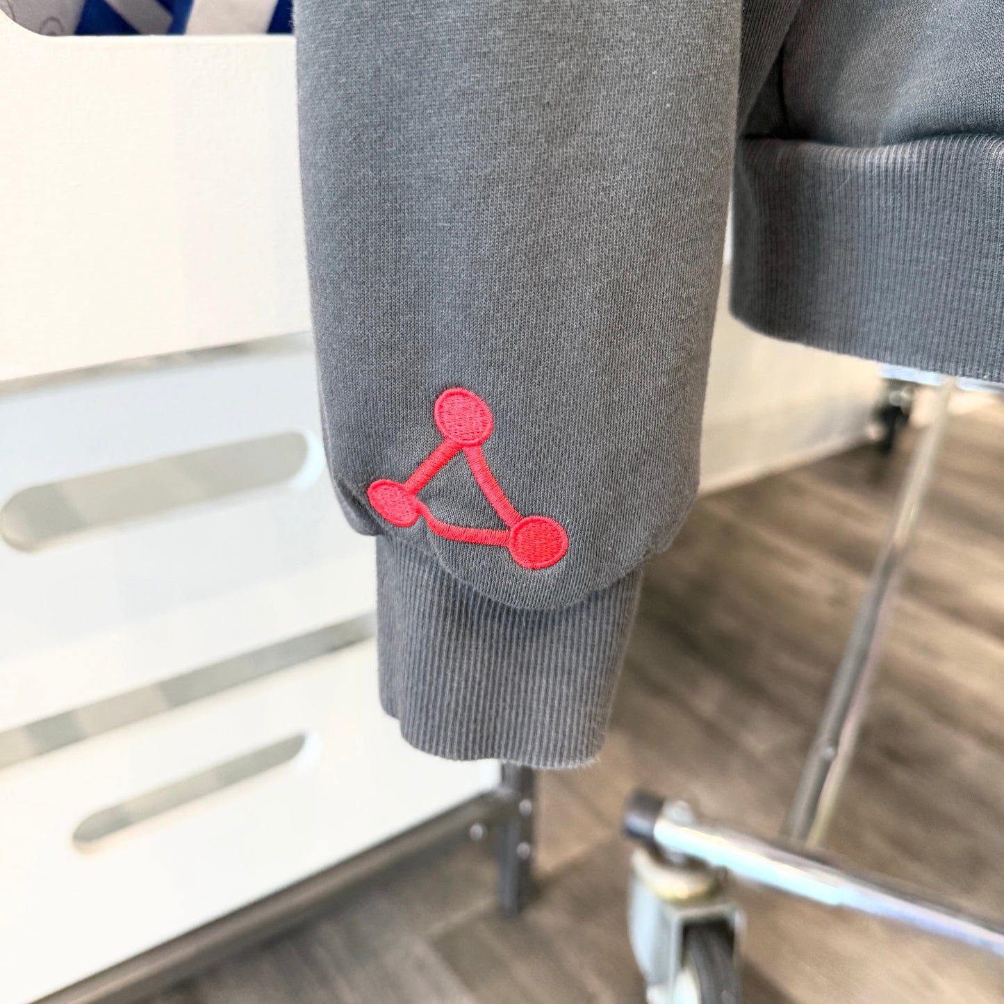 Grey hoodie sleeve with red Jujutsu Kaisen graphic 