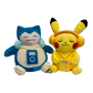 Plush toys of Pokemon Snorlax and Pikachu wearing headphones and holding a music player on a white background.