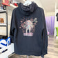 Black hoodie with Last of Us Infected graphic hanging in a store