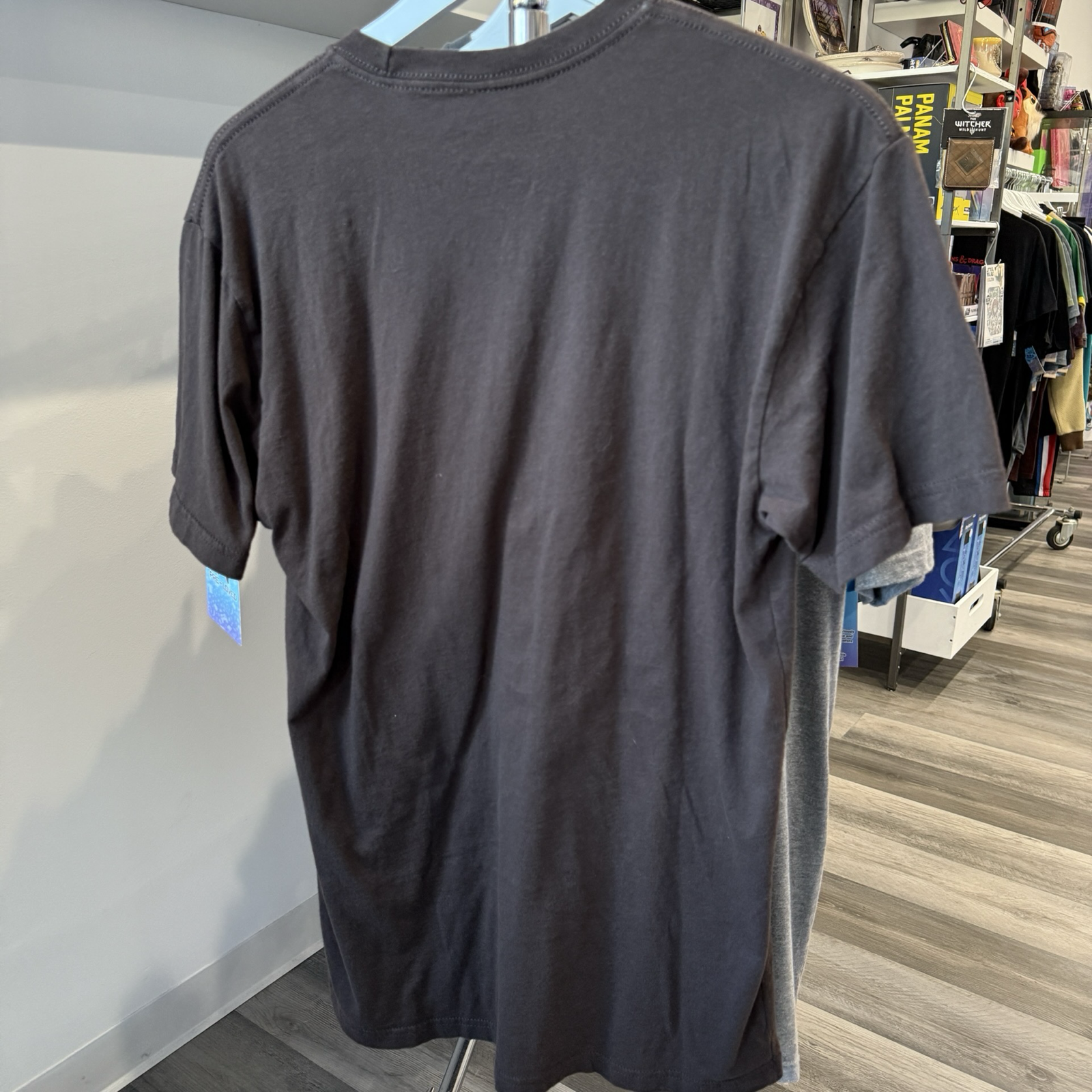 Back view of brown tshirt hanging on a rack