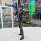 Action figure in a store setting with shelves in the background