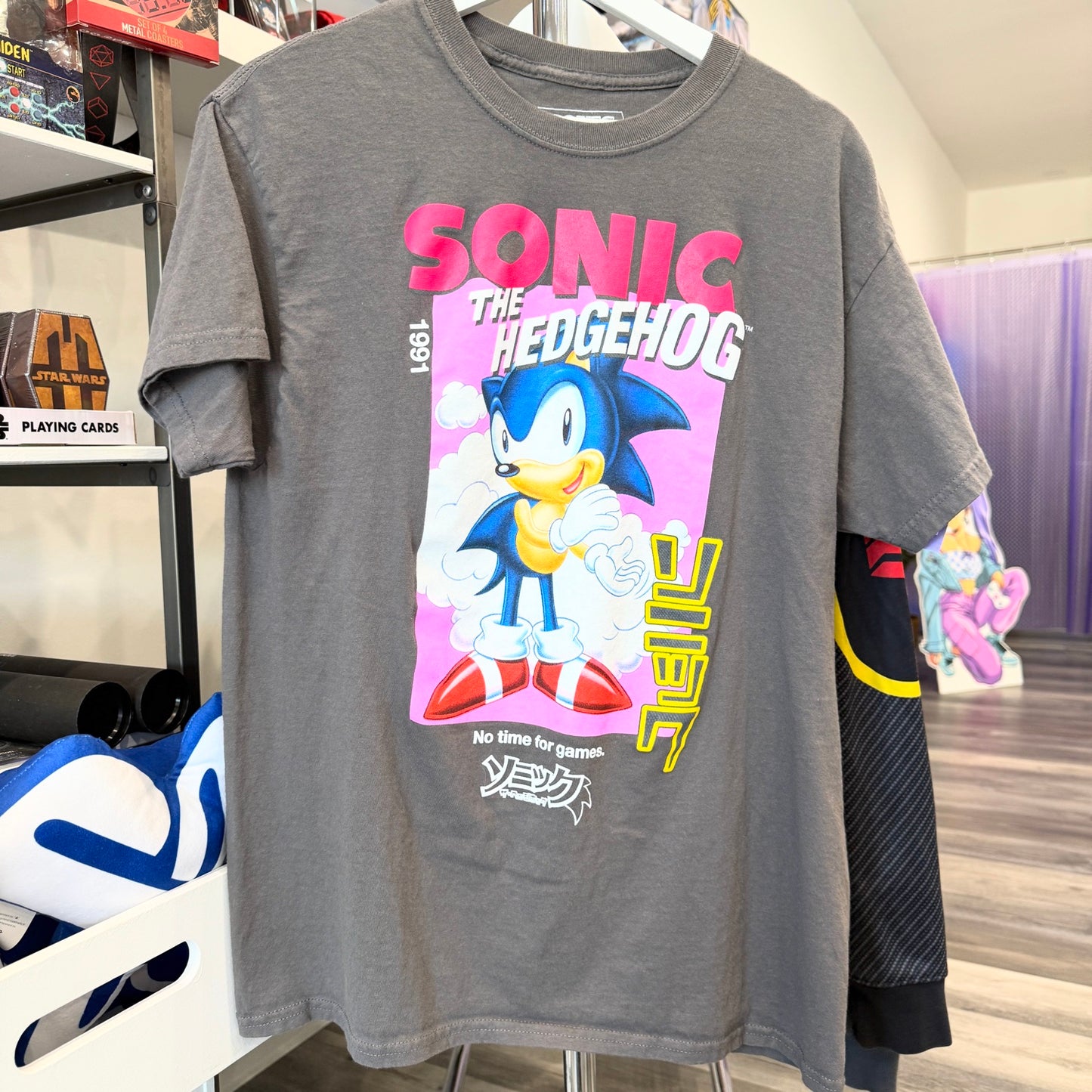 Gray t-shirt with Sonic the Hedgehog graphic design in a store setting