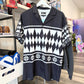 Black and white patterned shirt on a hanger in a store setting