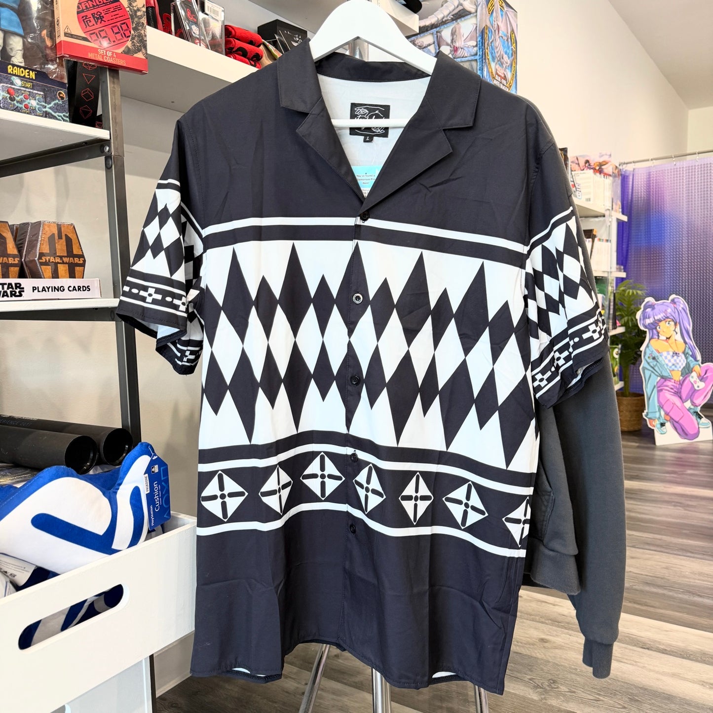 Black and white patterned shirt on a hanger in a store setting