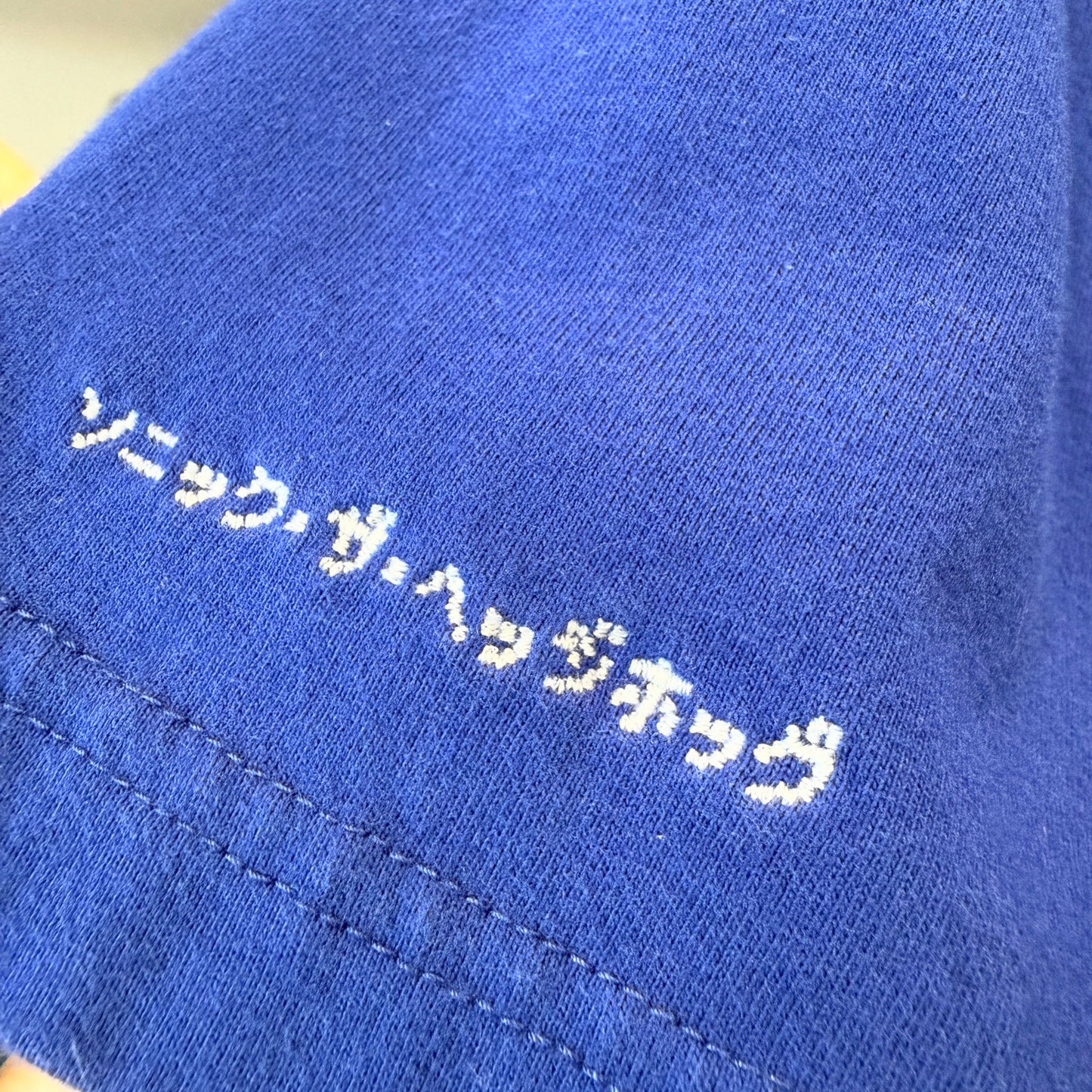 Shirt sleeve detail with Japanese text