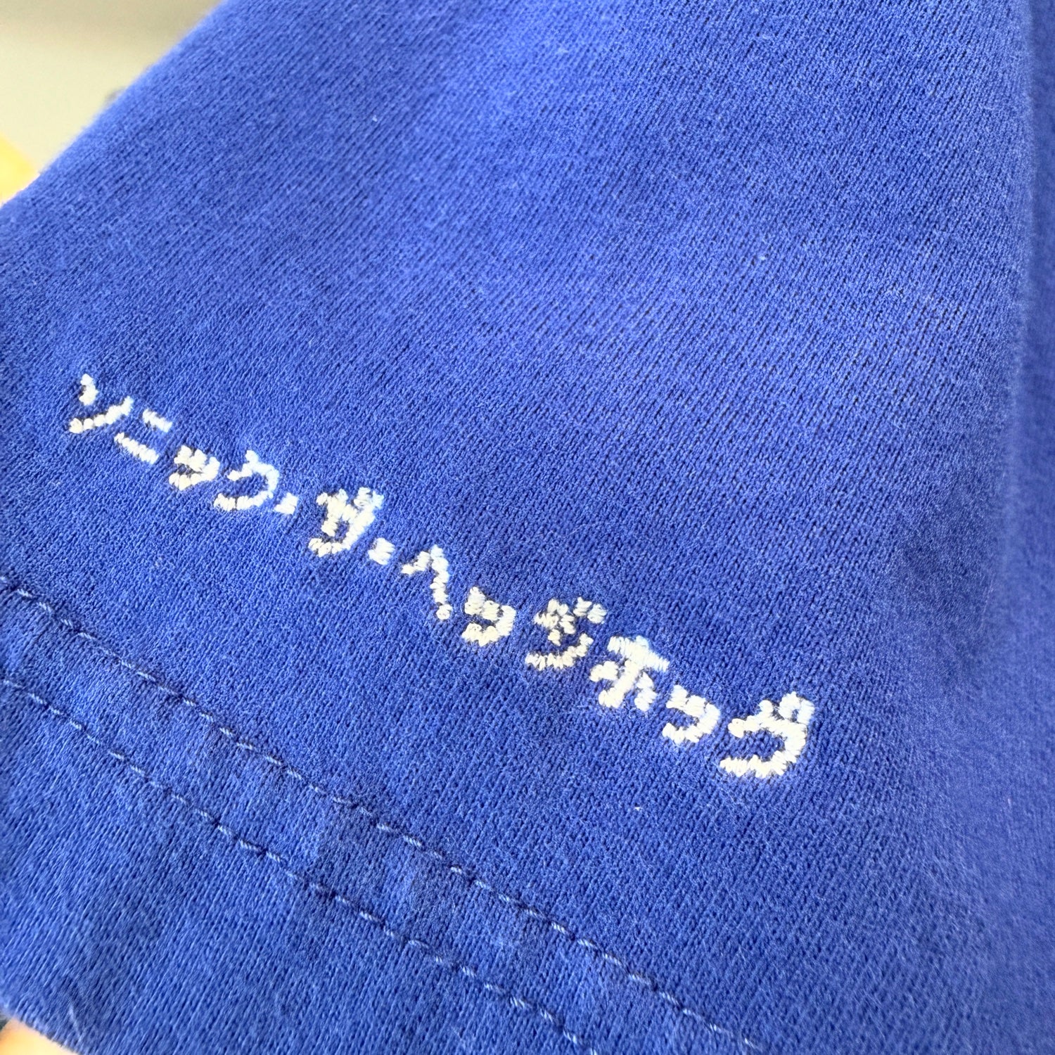 Shirt sleeve detail with Japanese text