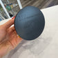 Bottom of figure base with writing that says "Red Collectible Vinyl Figure" "Supergiant Games" and "We Love Fine"