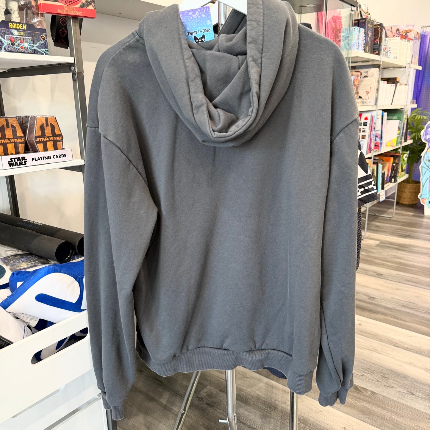 Back of grey hoodie in a store setting
