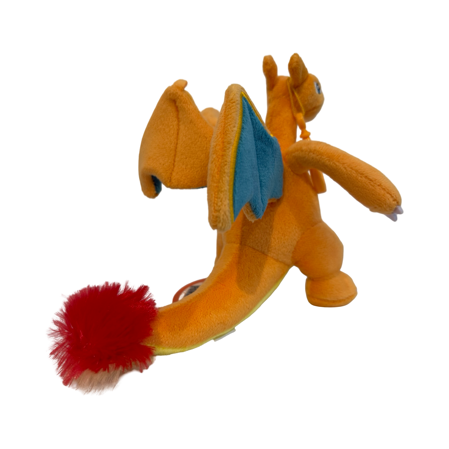 Plush keychain of Pokémon Charizard. Orange and yellow in color. 