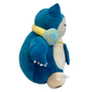 Plush Snorlax with headphones around his neck and music player hanging down. 