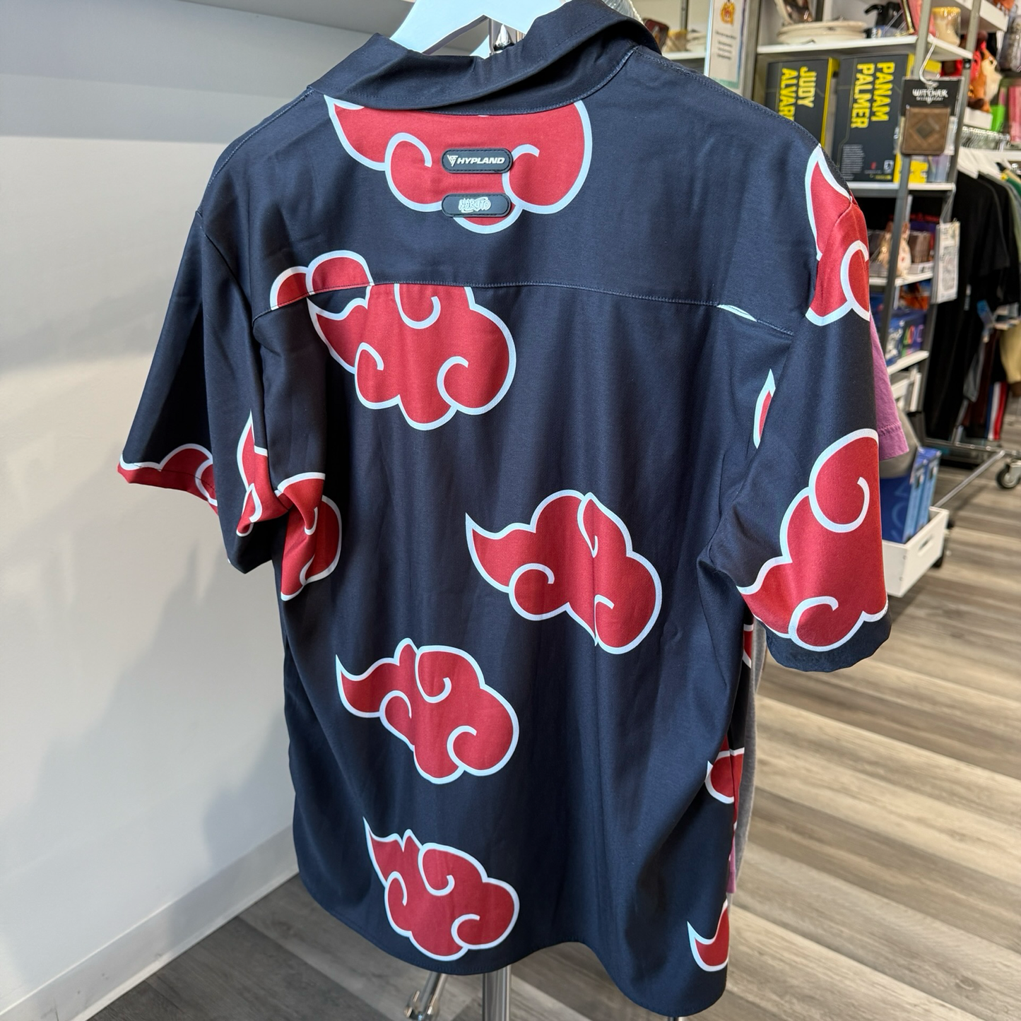 Back view of black shirt with white and red Akatsuki pattern graphic from the anime, Naruto. 