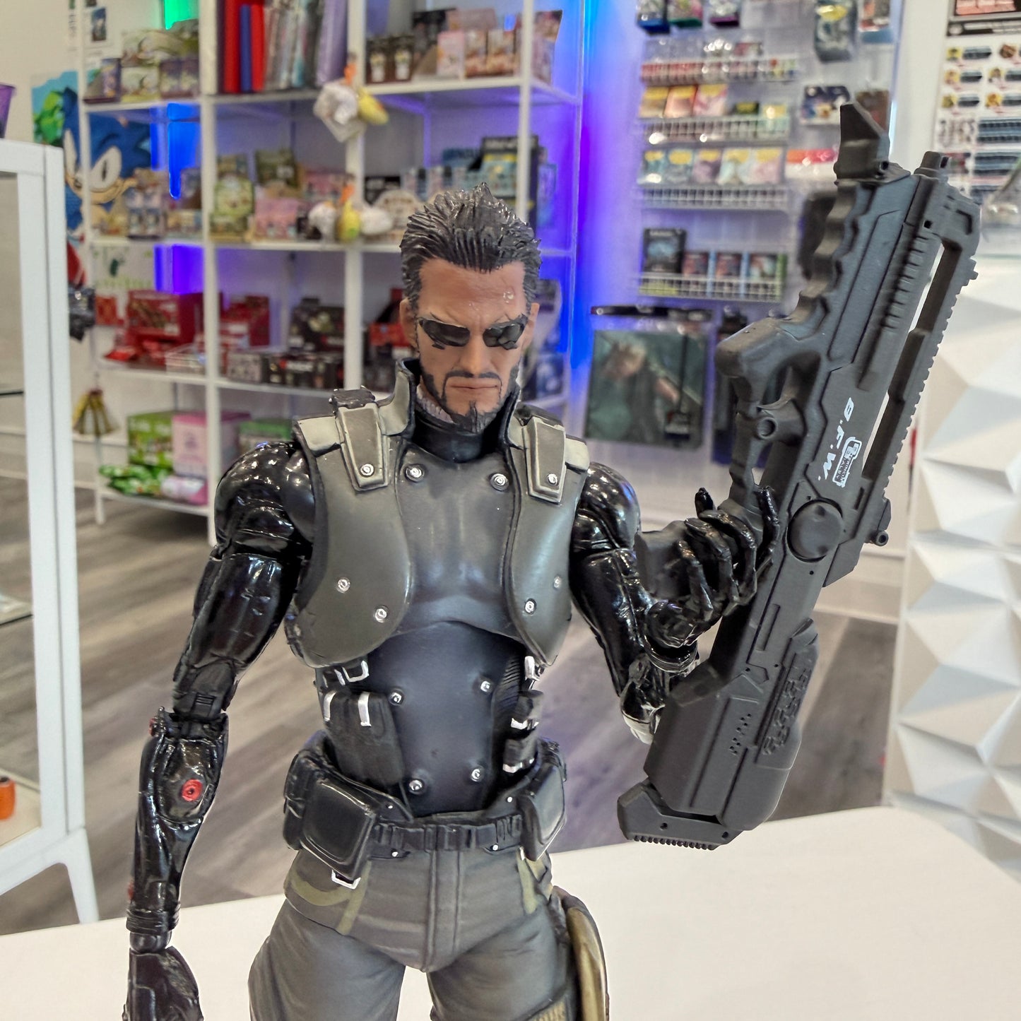 Action figure in a store setting with shelves in the background