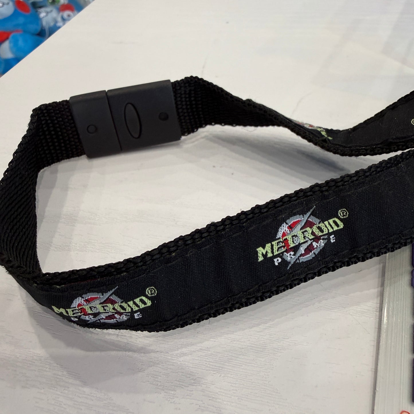 Black strap with 'Metroid Prime' logo on a white background