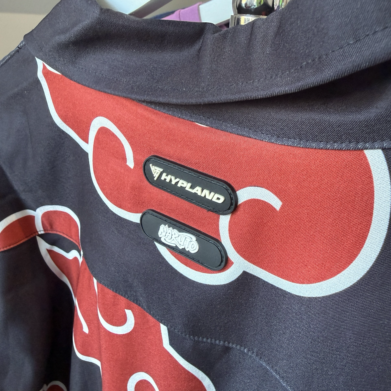 Close of details of silicone sewn on patches on a shirt of the Hypland and Naruto logos 