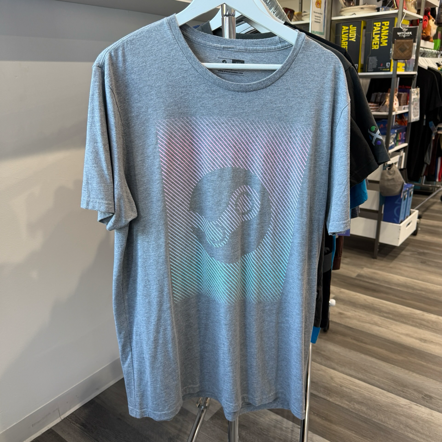 Heather grey tshirt with Steam logo done in pink, purple, and green ombre. 