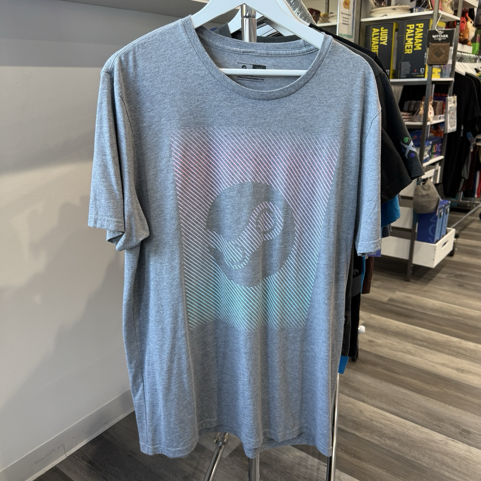 Heather grey tshirt with Steam logo done in pink, purple, and green ombre. 