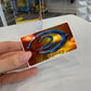 Hand holding metallic sticker of the Halo 2 logo 