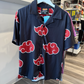 Black button up shirt with Akatsuki cloud design in red and white from the anime, Naruto. 