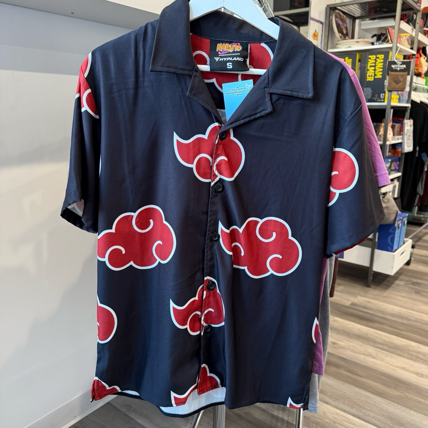 Black button up shirt with Akatsuki cloud design in red and white from the anime, Naruto. 