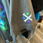Upclose of grey tshirt sleeve Alolan Marowak graphic