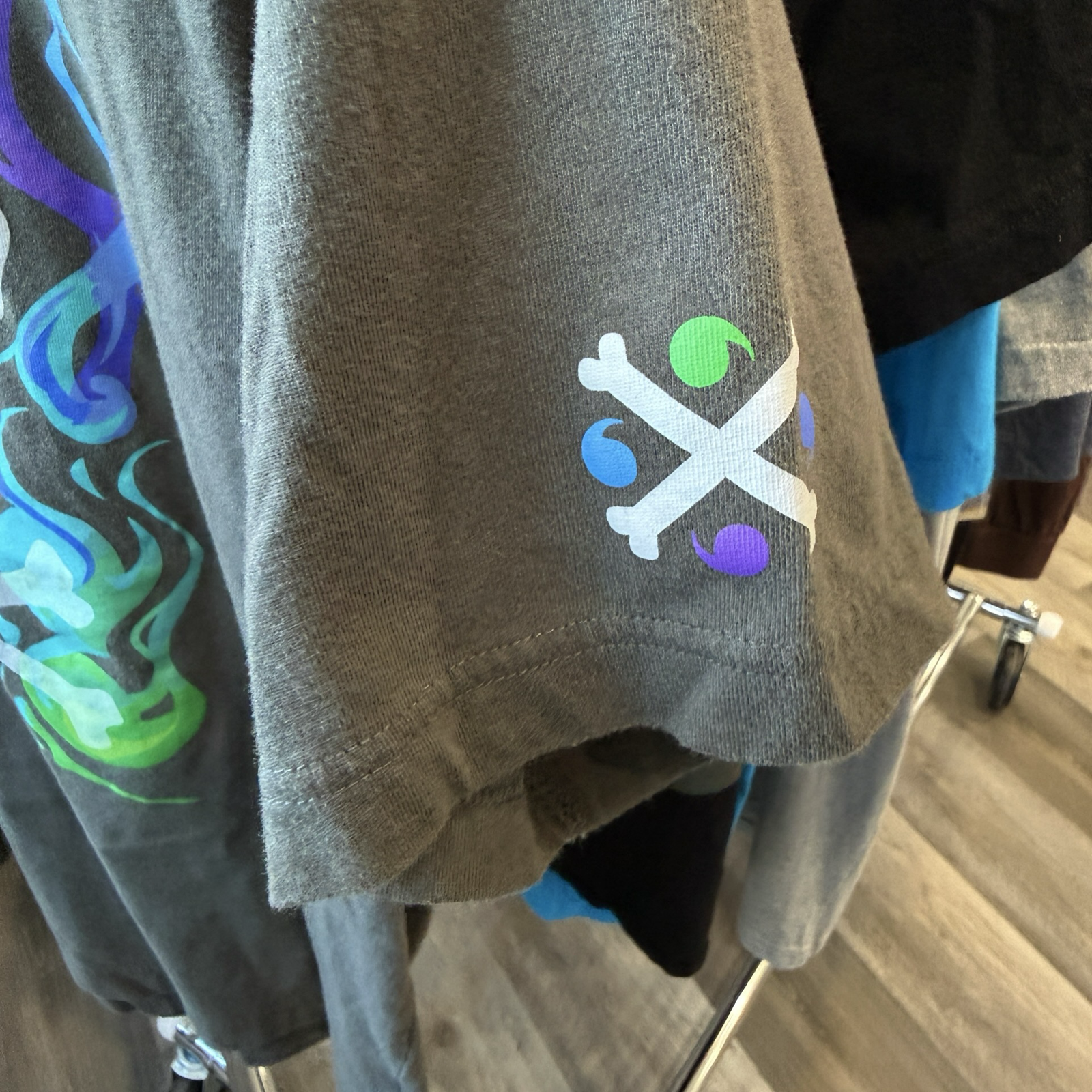 Upclose of grey tshirt sleeve Alolan Marowak graphic