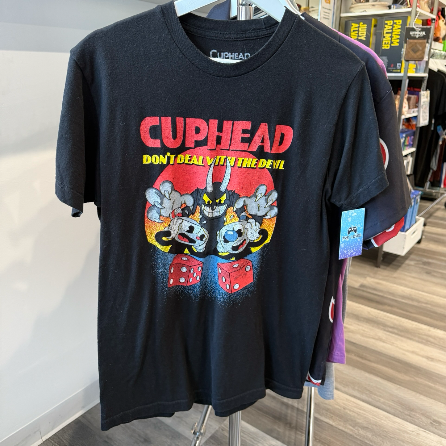 Black tshirt with Cuphead Deal with the Devil graphic in red, yellow, and black. 