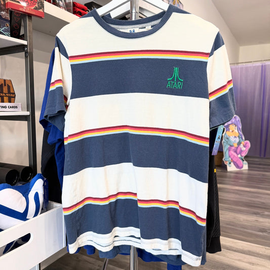 Striped shirt with Atari logo on a rack in a store setting