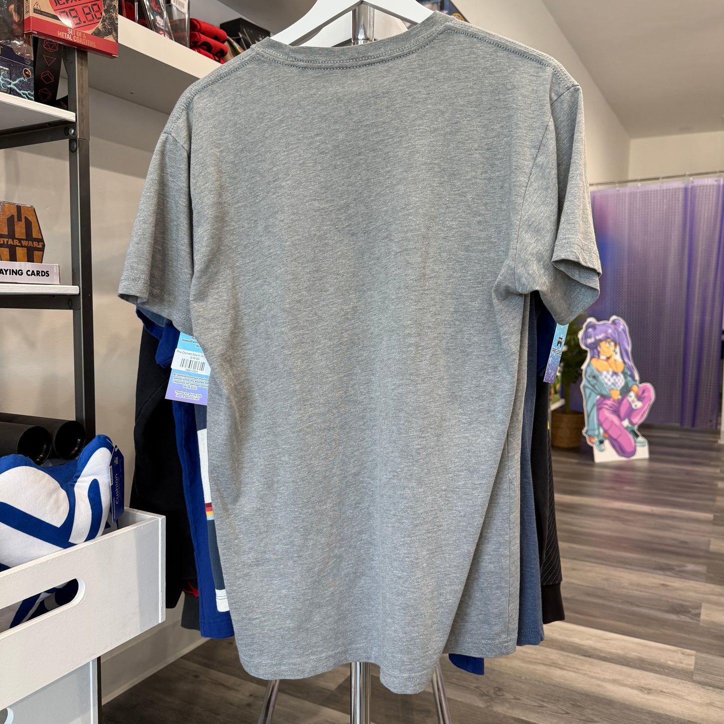 Gray tshirt hanging inside a store