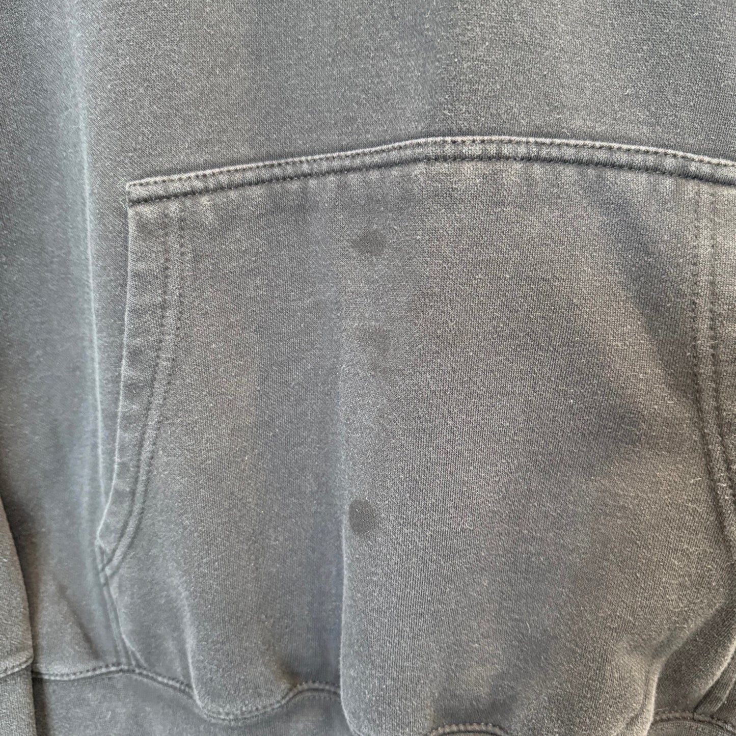 close up of sweatshirt pocket showing a few dark stains