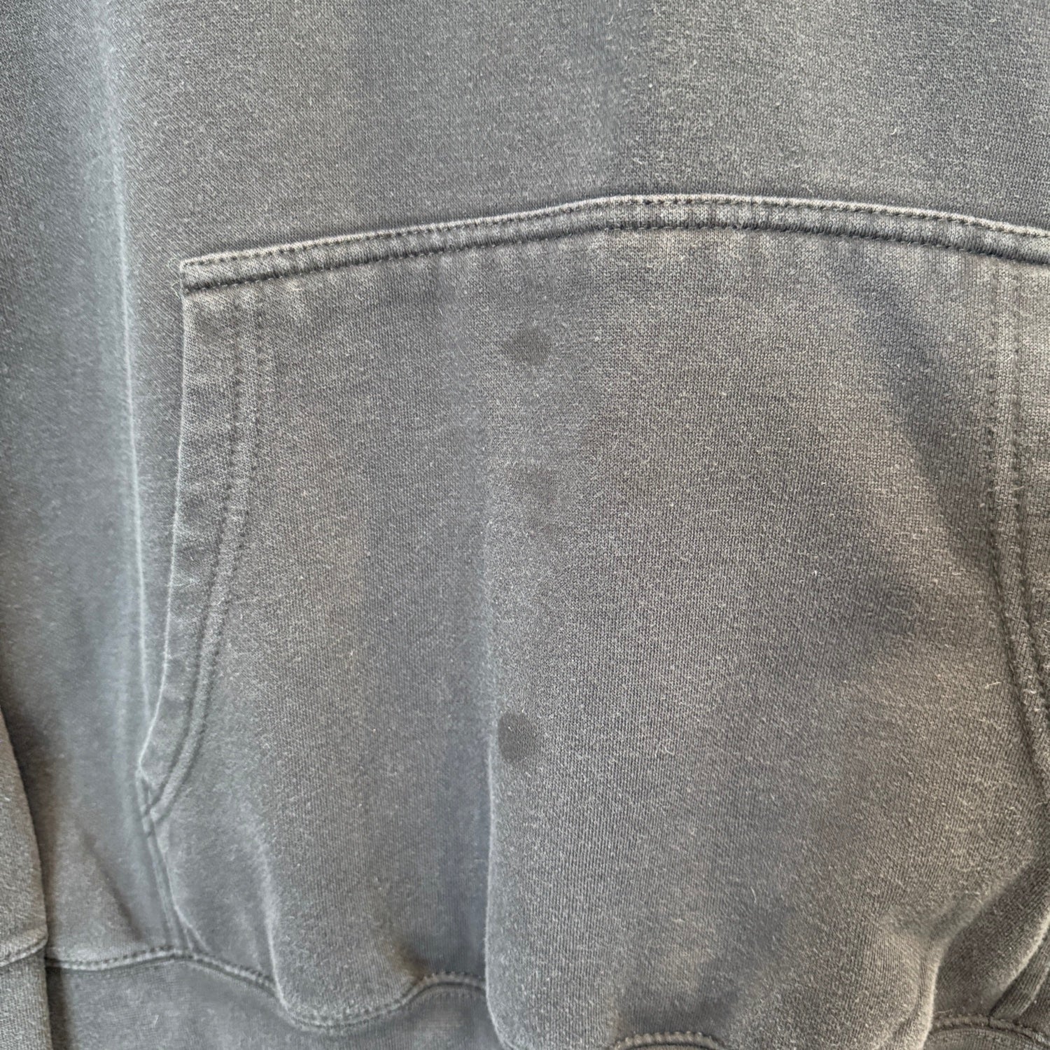close up of sweatshirt pocket showing a few dark stains