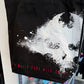 Close up of a black canvas tote bag with graphic from the video game, The World Ends With you on the front. 