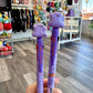 Two purple pens featuring the Pokemon, Ditto with a store in the background
