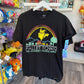 A black short-sleeve graphic t-shirt hanging on a white hanger in a retail store. The shirt features a colorful retro-style graphic of Pikachu under a rainbow with the text 'PALLET TOWN THE JOURNEY STARTS HERE!'.