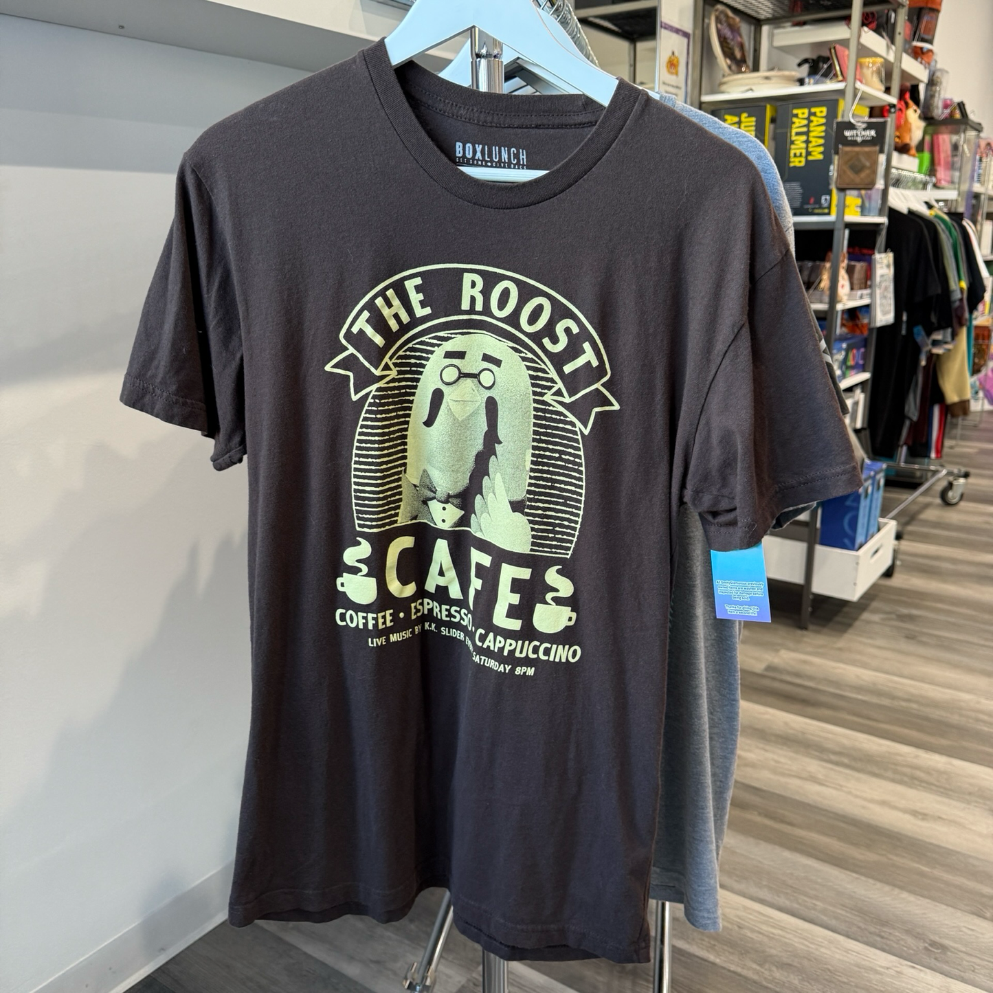 Dark brown tshirt wit offwhite color graphic of the pigeon character, Brewster from the video game series Animal Crossing