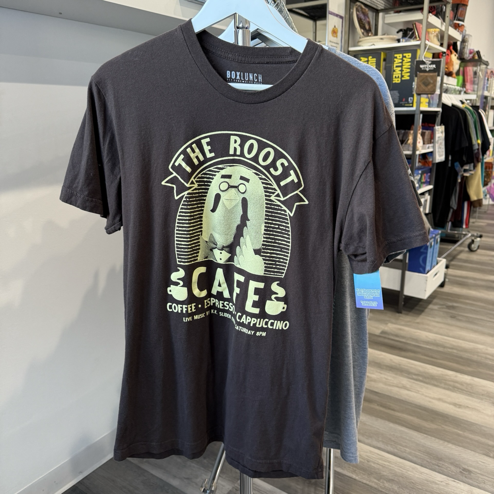 Dark brown tshirt wit offwhite color graphic of the pigeon character, Brewster from the video game series Animal Crossing