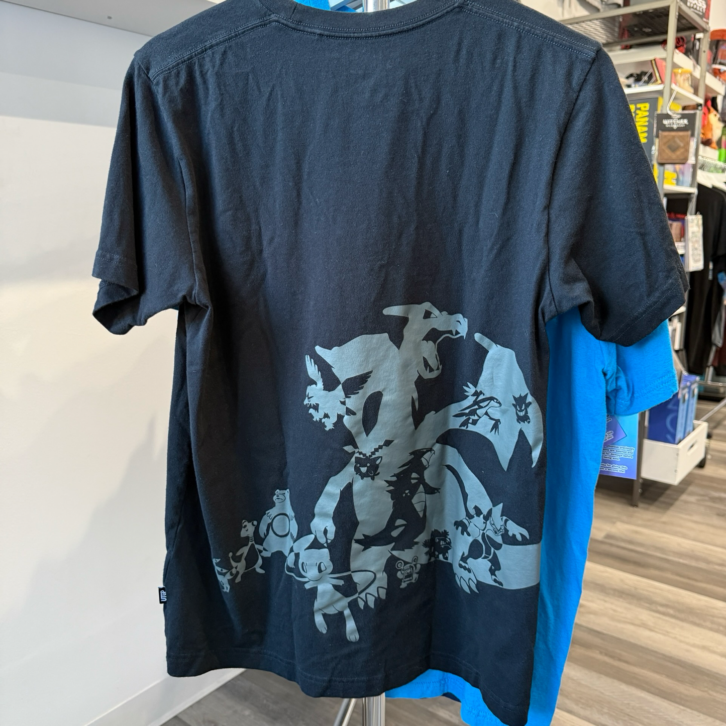Black tshirt with grey print of various Pokémon 
